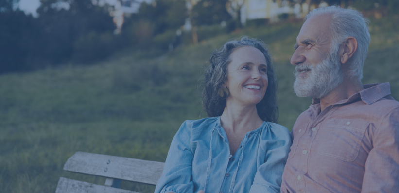 Woman supporting man on park bench